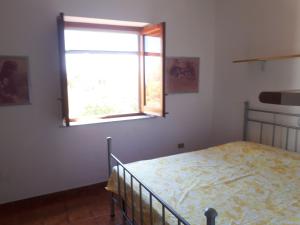a bedroom with a bed and a window at Casa Nicoletta in Ustica