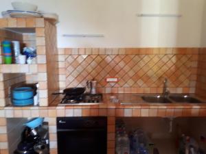 a kitchen with a stove and a sink at Casa Nicoletta in Ustica