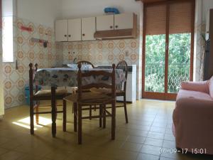 a kitchen with a table and chairs in a room at Villa Spaia in Brancaleone Marina