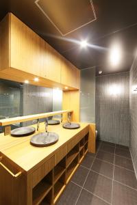 a public bathroom with two sinks in a room at Small Luxury Ryugin in Kyoto