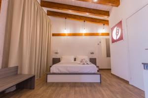 a hotel room with a bed and a dresser at Il Semaforo Sila Hotel in Taverna