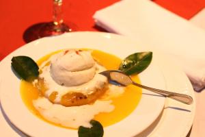 a plate of food with ice cream on a table at Hacienda La Isla Lodge in Sarapiquí