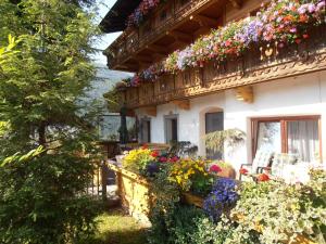 a house with flowers on the side of it at Mesnerhof Virgen in Virgen