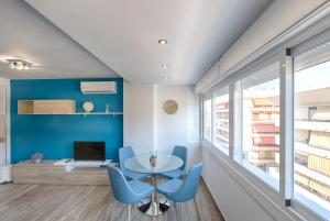 Zimmer mit einem Glastisch und blauen Stühlen in der Unterkunft Estepona Real Classic Apartamento in Estepona