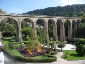 a viaduct with a train on top of it at Refúgio da Vila - Refuge of the Village in Vouzela