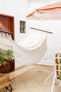 a hammock in a room with a bed at D'lujo in Bogotá