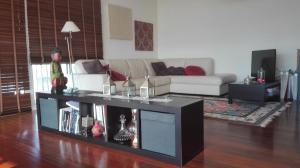 a living room with a couch and a table at Zen Caniço Apartment in Caniço