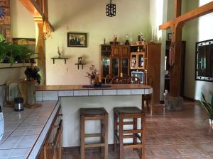 a kitchen with a counter and some stools at Casa Cora Bed and Breakfast in Colonia Carmona