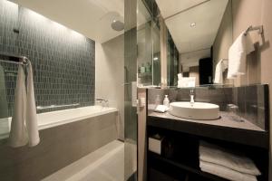 a bathroom with a sink, toilet and bathtub at Solaria Nishitetsu Hotel Seoul Myeongdong in Seoul