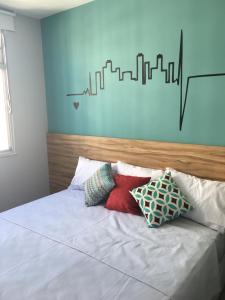 a bed with pillows on it in a bedroom at Loft Paris in Niterói +64 photos
