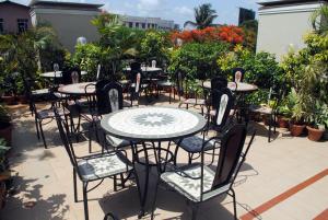 a group of tables and chairs sitting on a patio at Hotel Airlines International in Mumbai