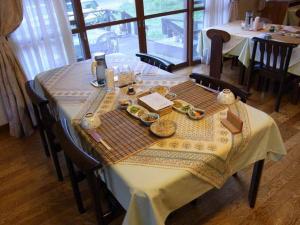 a table with a table cloth with food on it at Pension Rapport in Tambara Plateau in Numata