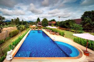 an overhead view of a swimming pool with umbrellas at Sawasdee Sukhothai Resort in Sukhothai