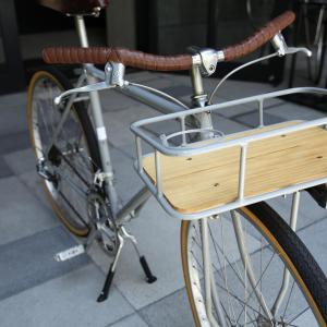 a bicycle parked on a sidewalk next to a bike rack at TRUNK (HOTEL) in Tokyo