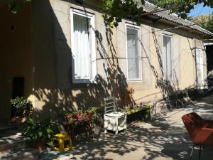 a shadow of a house with a chair and plants at Jeffrey+ in Bolnisi