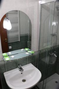 a bathroom with a sink and a mirror at Shipka IT Hotel in Shipka