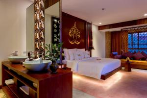 a bedroom with a large bed and a bathroom at Golden Temple Boutique in Siem Reap +85 photos