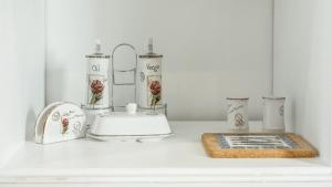a white counter with a sink and vases on it at Best Stay-Pärnu Villa in Pärnu