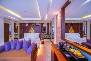 a bedroom with two beds and a large mirror at Golden Temple Boutique in Siem Reap