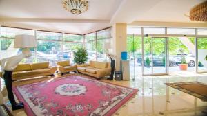 a living room with a couch and a rug at Hotel Borjomi Aisi in Borjomi +73 photos