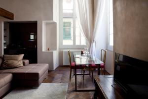 a living room with a couch and a glass table at Charming Genova | Residenza d'epoca in Genoa