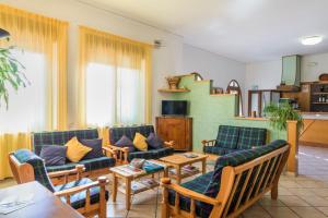 a living room with couches and a table at Hotel Cristina in San Rocco di Piegara
