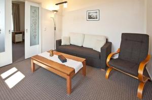 a living room with a couch and a chair at Villa Elfriede in Sassnitz