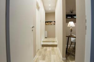 a hallway with a stairway with a table and a lamp at Bagnasco 18 suite&terrace in Palermo