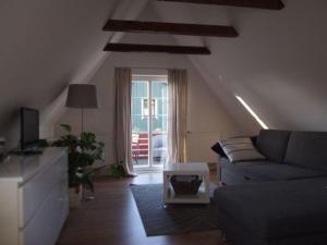 a living room with a couch and a table at Reetdach - Promenadenblick - 500m zum Strand in Prerow