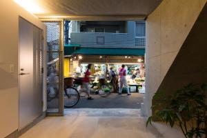 a view of a market with people walking through a doorway at URBAN LODGE Komagome in Tokyo