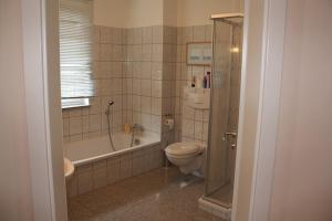 a bathroom with a tub and a toilet and a shower at Landhaus Storchenblick - WE-20160 in Lonvitz