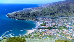 an aerial view of a town next to the ocean at Estacada Apartment in Machico