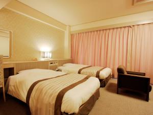 Postel nebo postele na pokoji v ubytování Misasa Royal Hotel