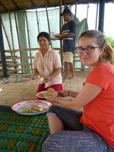 two women are eating food in a hut at Battambang Dream Bungalows in Battambang
