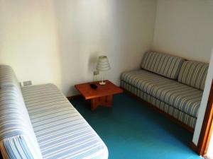 a small room with a couch and a table at Hotel Kyrie Isole Tremiti in San Domino