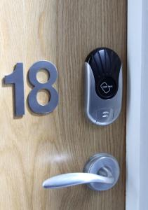 a wooden door with a number and a door knob at Mojitos Group Weekends Blackpool in Blackpool