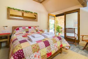 a bedroom with a bed with two pillows on it at Widbrook Barns in Bradford on Avon