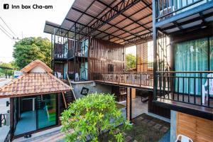 an outside view of a building with a balcony at Inn Box ChA-AM in Cha Am