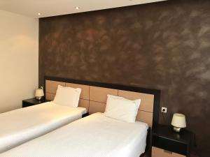 Postel nebo postele na pokoji v ubytování Hotel Kardinal