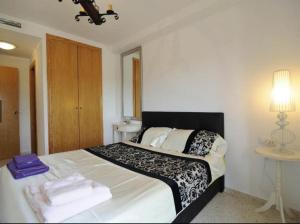 1 dormitorio con 1 cama grande y toallas. en First line apartment, en Alboraya
