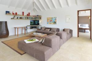 a living room with two couches and a table at Villa Jali in Gustavia