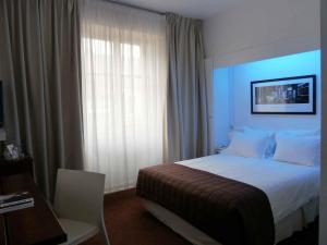 Postel nebo postele na pokoji v ubytování Le Grand Hotel