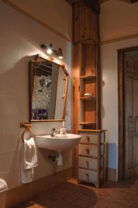 a bathroom with a sink and a mirror at Mas Puigdevall in Vall de Bianya