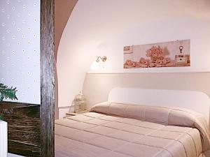 a bedroom with a bed and a table with a lamp at Il Casale dei Principi in Lecce