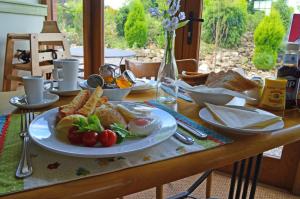 a wooden table with a plate of food on it at Widbrook Barns in Bradford on Avon