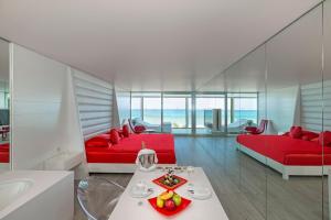 a living room with two red beds and a table at Adam & Eve - Adult Only in Belek