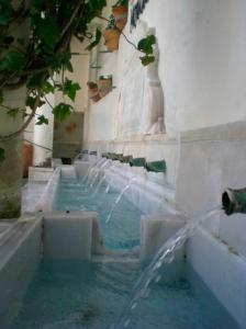 a water fountain in a building with water coming out at Casa Rural La Fuensanta in Mojácar
