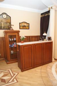 a room with a counter and a clock on the wall at Apartment Dynasty in Novosibirsk