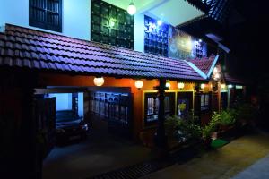 a building with a car parked outside at night at Kovalam Beach Hotel in Kovalam