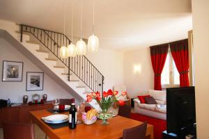 a living room with a dining table and a staircase at Apartment Theresa in Tremezzo